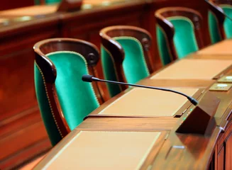 Empty vintage congress hall with seats and microphones. © denys_kuvaiev