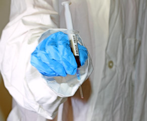 doctor with the syringe of blood of ebola virus