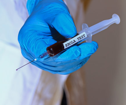 blue glove nurse during testing of the ebola virus