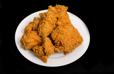 Fried Chicken on White Plate and Black Background