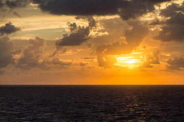 Naklejka premium Orange Sunset Over Grey Seas