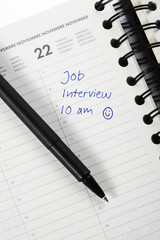 Pen and diary entry for job interview, close up