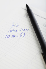 Pen and diary entry for job interview, close up