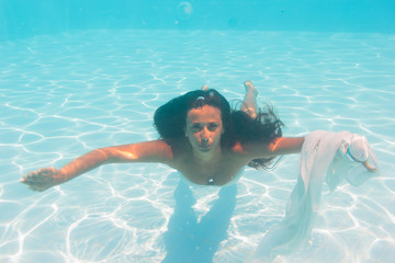 Young woman swimming undewater