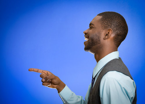 side profile man laughing pointing with finger at someone