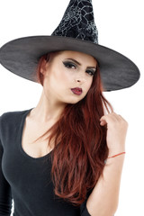 Fototapeta na wymiar pretty young redhead witch, isolated against white background