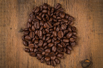 Coffee beans on grunge wooden background