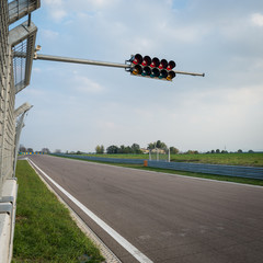 Empty formula one circuit with traffic lights.