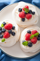 pavlova meringue cake with cream and berry