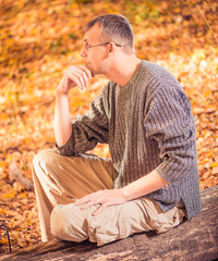 man in sweater at fall forest