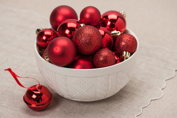 Christmas Decoration. Red Balls And Bells. Natural Linen Backgro