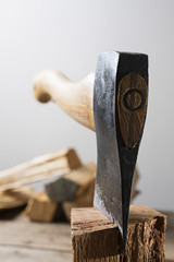 Old wooden handle axe in a block of wood