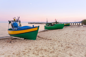 Baltic beach with fishing boat at sunset, Poland