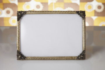 Blank picture frame against kitsch background