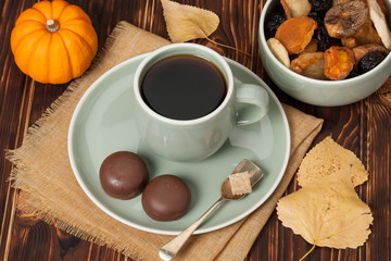 Fototapeta na wymiar Autumn Concept. Cup Of Tea Or Coffee. Dried Fruits. Chocolate Sw
