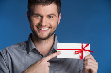 Present gift in hands of smiling man.
