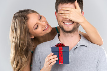 romantic woman covering her boyfriend's eyes.