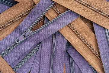 purple and brown clothing zippers © Gabriel Cassan