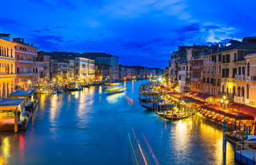 Night view of Grand Canal with gondolas in Venice. Italy