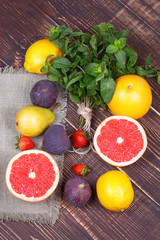 Grapefruits, pears, lemons, figs, strawberry, pomelo; still life