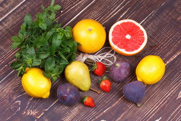 Grapefruits, pears, lemons, figs, strawberry, pomelo; still life