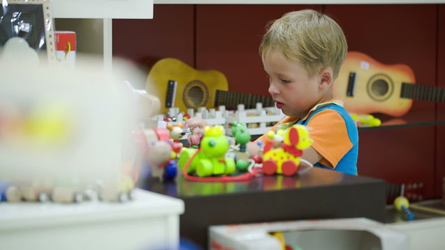 Boy playing with toys in game room