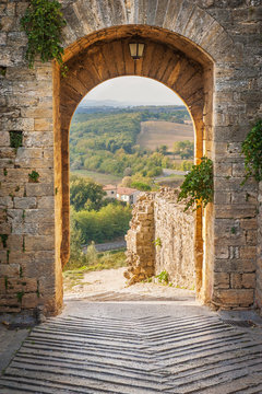 Exit the town of Monteriggioni with views of the Tuscan landscap