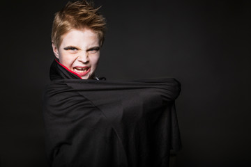 Cute boy dressed up as vampire for the halloween party