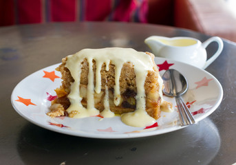 Slice of freshly baked apple crumble with cream