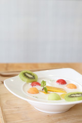 yogurt with fruit on wood background