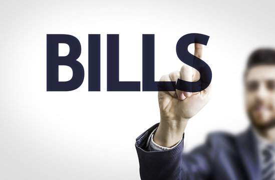 Business man pointing to transparent board with text: Bills