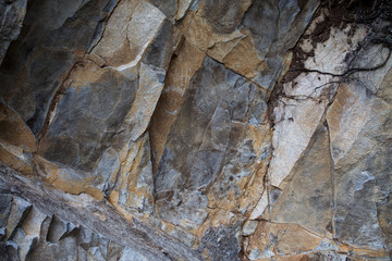 Fragment of rough-hewn stone of dark gray