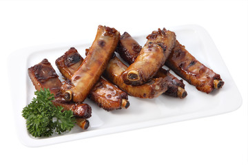 grilled pork ribs on a plate isolated on white