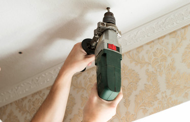 The process of drilling with an electric drill