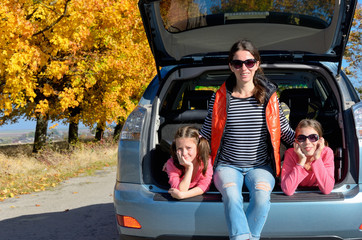 Car trip on autumn family vacation, mother and kids travel