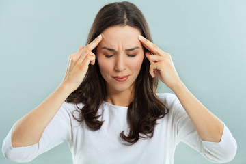 Young woman having a headache. Studio shot.