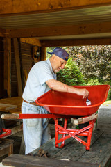 Senior  paint  a wheelbarrow in red