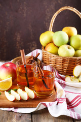 still life with apple cider and fresh apples on wooden table
