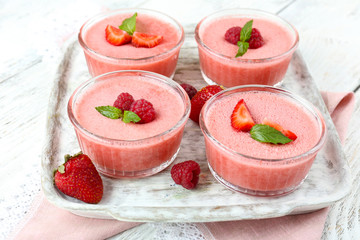 Delicious berry mousse in bowls on table close-up