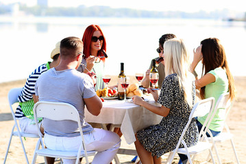 Happy friends on rest at beach