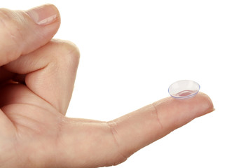 Contact lens on finger isolated on white