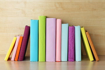 Fototapeta na wymiar Books on wooden shelf close-up