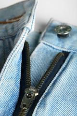 Zipper and button on clothes close up