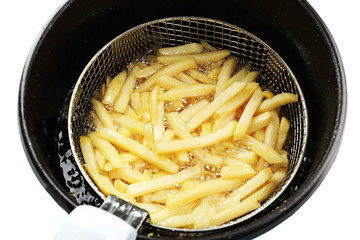French fries in deep fryer, closeup