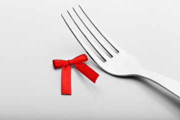 Stages of tying bow on fork, close-up