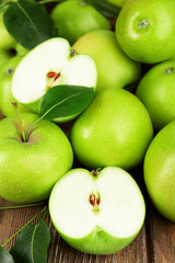 Ripe green apples on wooden background