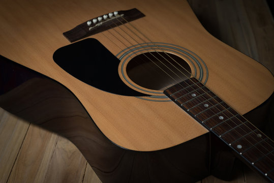 acoustic guitar on wooden background