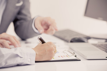 Businessman analyzing investment charts with laptop. Accounting