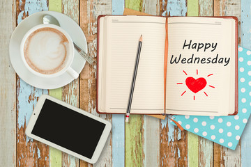 "Happy Saturday"on notebook with smart phone and coffee cup