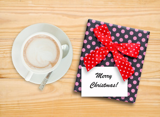 Merry Christmas note on gift box with coffee cup